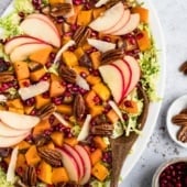 autumn butternut squash brussels sprouts caesar salad on a platter