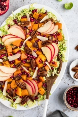 autumn butternut squash brussels sprouts caesar salad on a platter