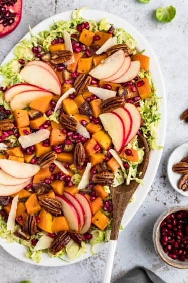 autumn butternut squash brussels sprouts caesar salad on a platter