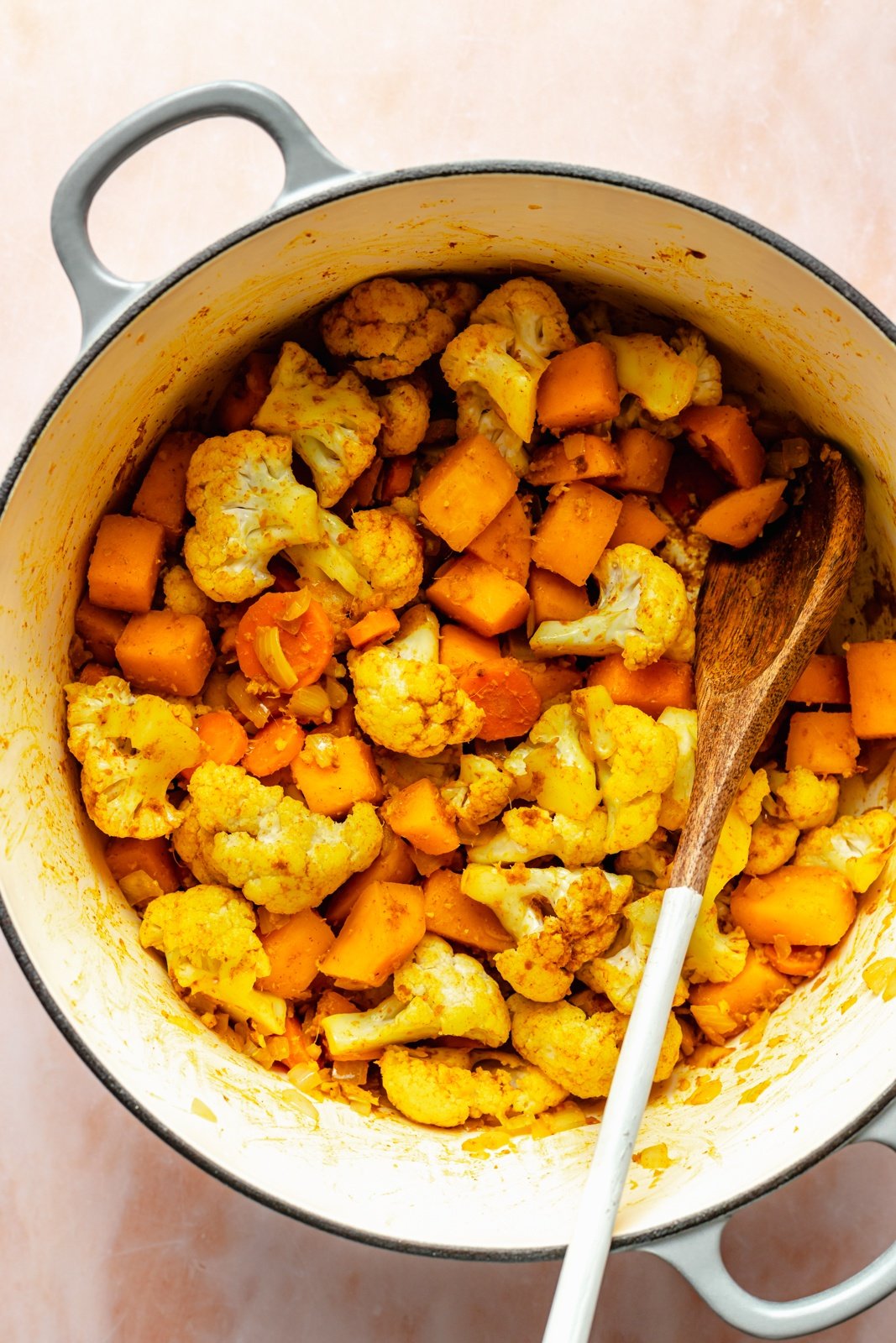 cooking vegetables to make vegan butternut squash curry