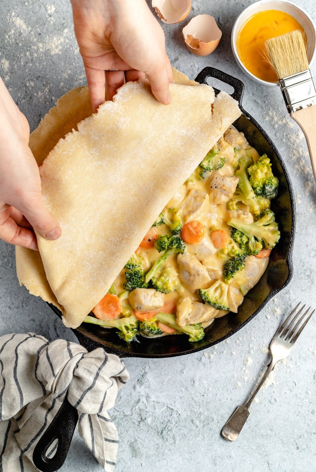 adding a crust onto cheddar broccoli chicken pot pie