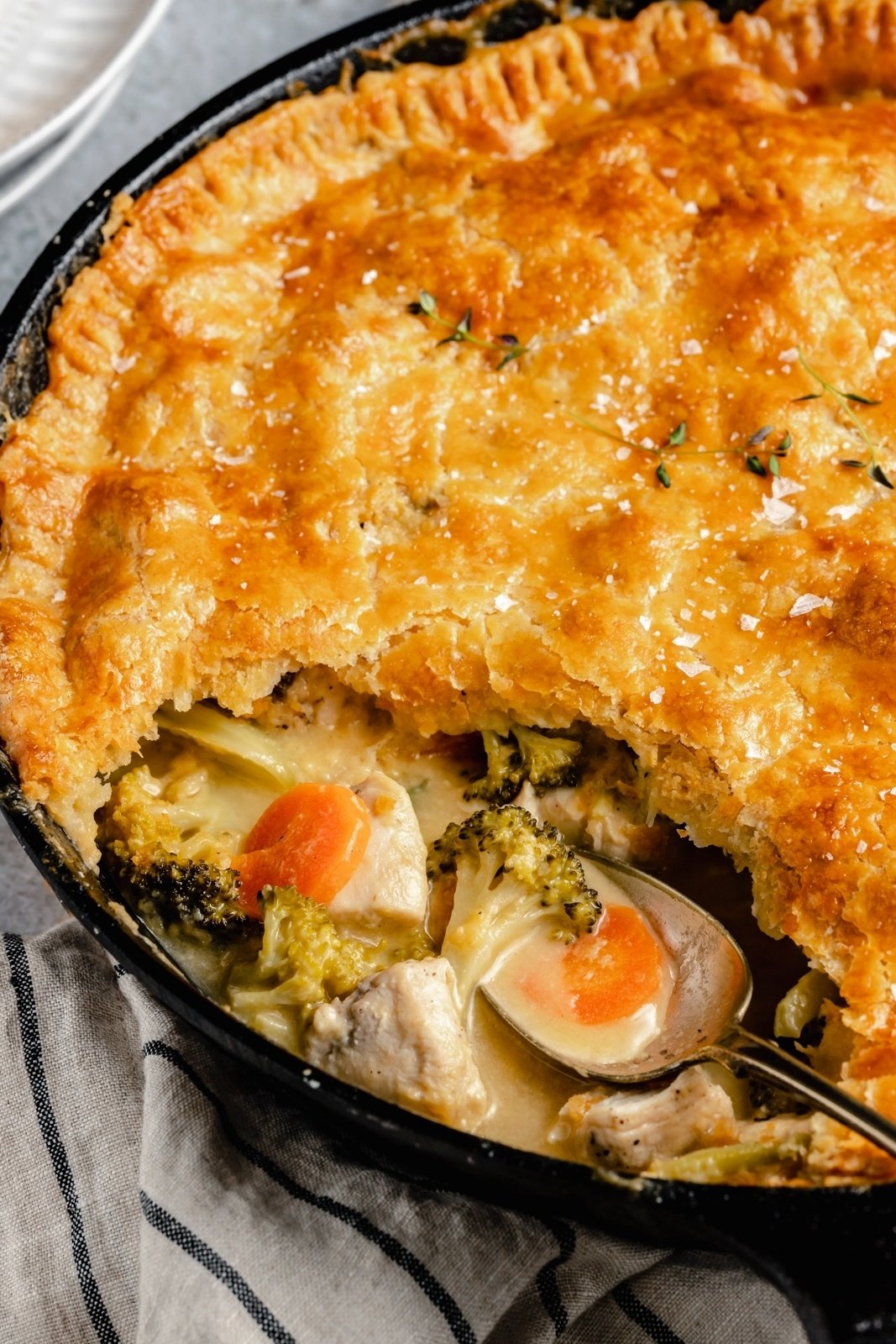 cheddar broccoli chicken pot pie with a spoon in it