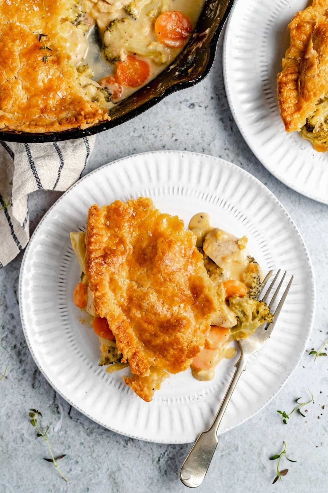 piece of broccoli cheddar chicken pot pie on a plate with a fork