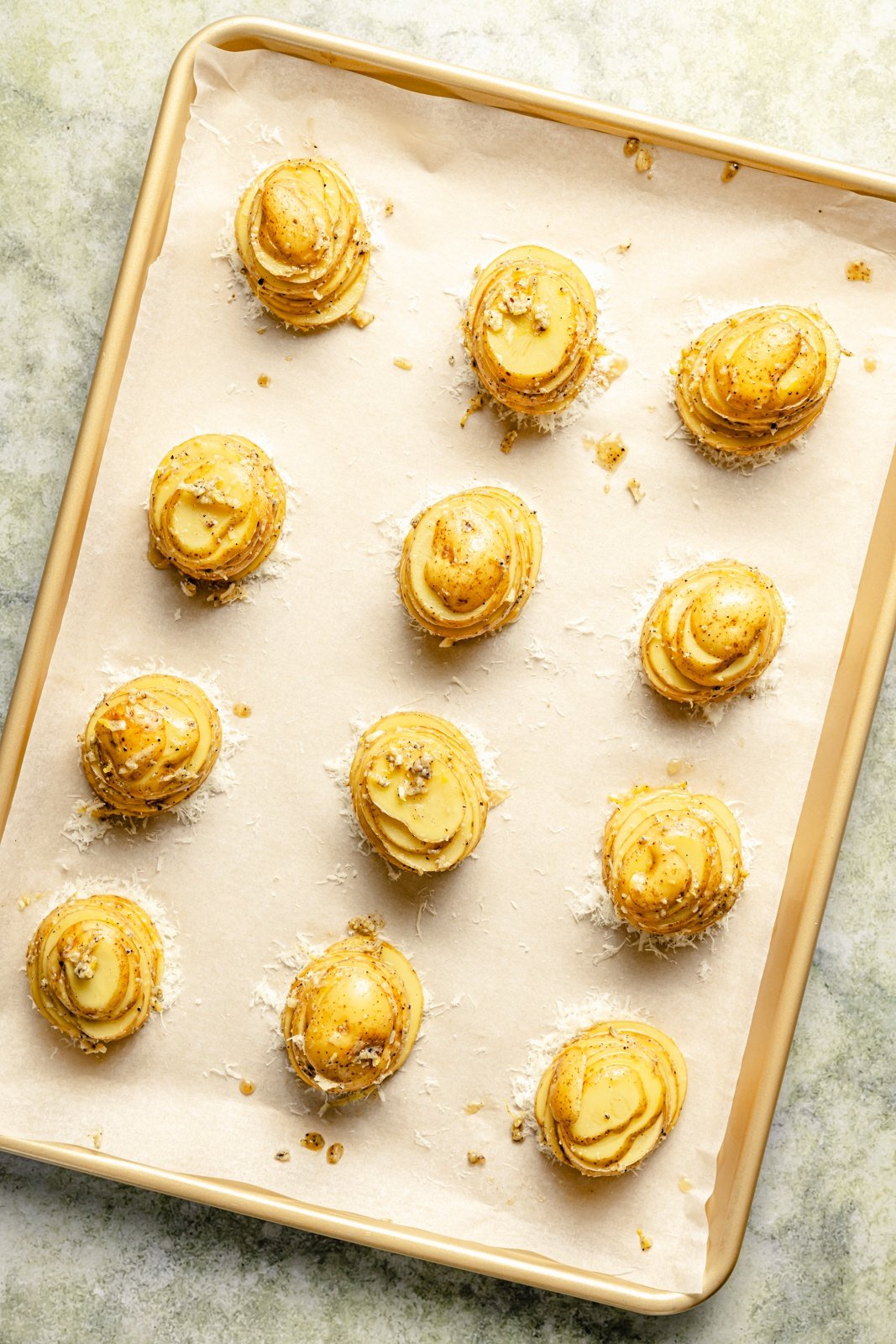 unbaked roasted potato stacks on a baking sheet