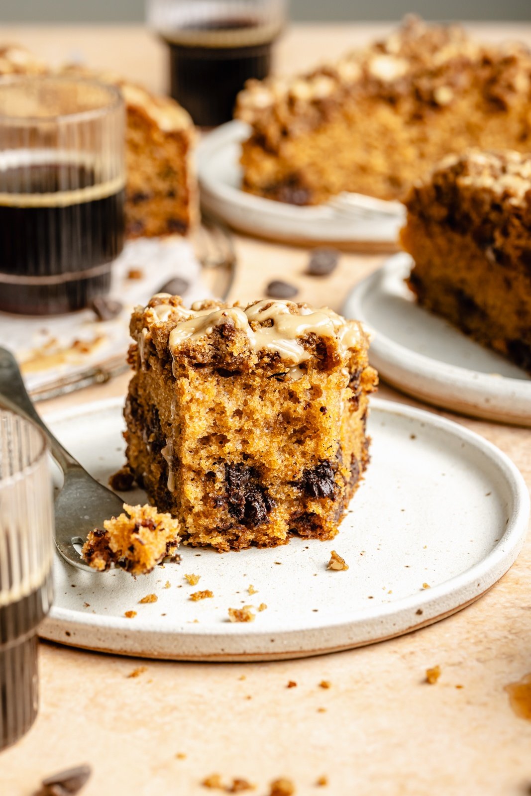 slice of espresso chocolate chip coffee cake on a plate with a bite taken out
