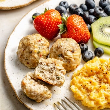plate of apple chicken meatballs, fruit, and eggs