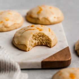 Italian iced orange cookies with icing on a marble board