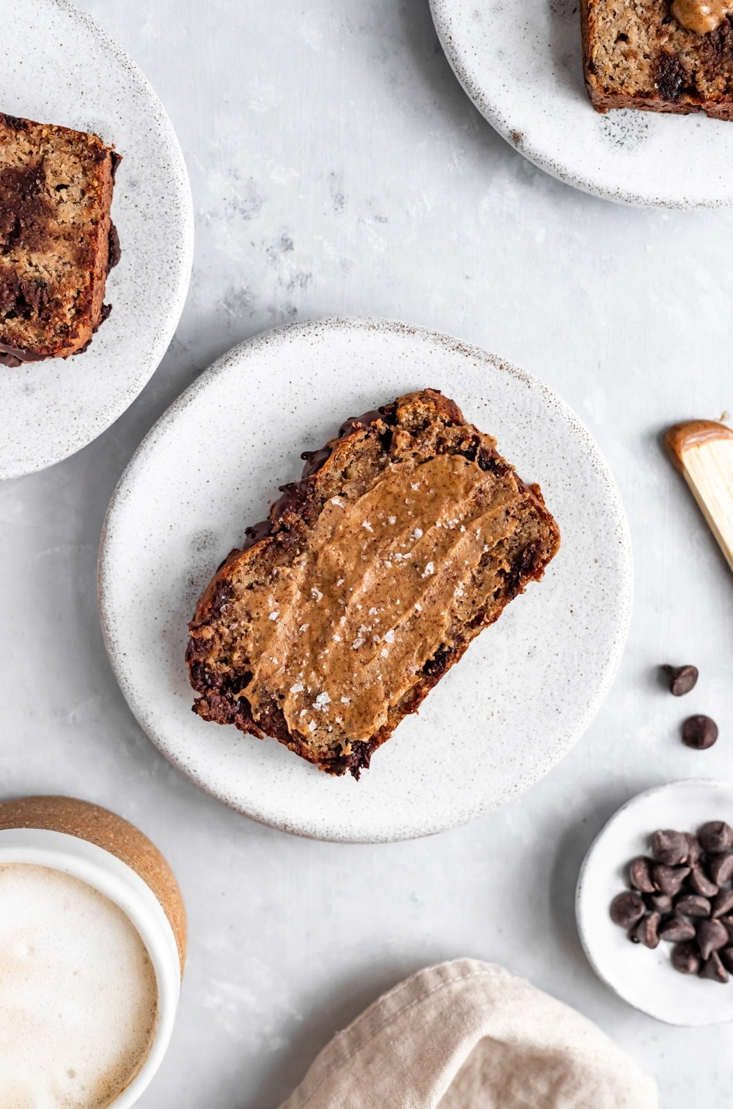 slice of almond flour banana bread topped with almond butter on a plate