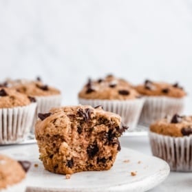 gluten-free chocolate chip zucchini muffin on a plate with a bite taken out