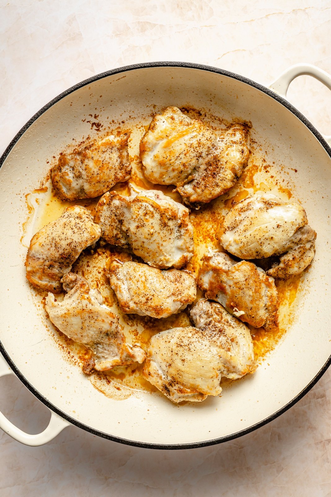 cooking chicken in a pan for a caprese baked orzo recipe