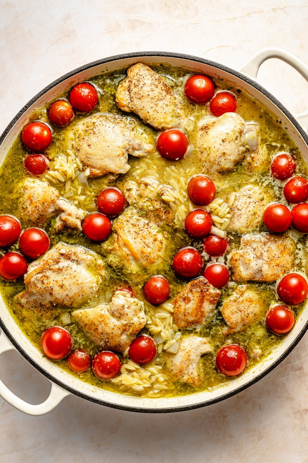 cooking chicken caprese baked orzo in a pan