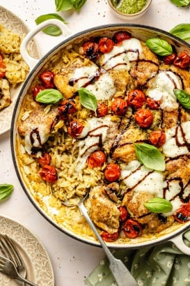 chicken caprese orzo bake in a pan