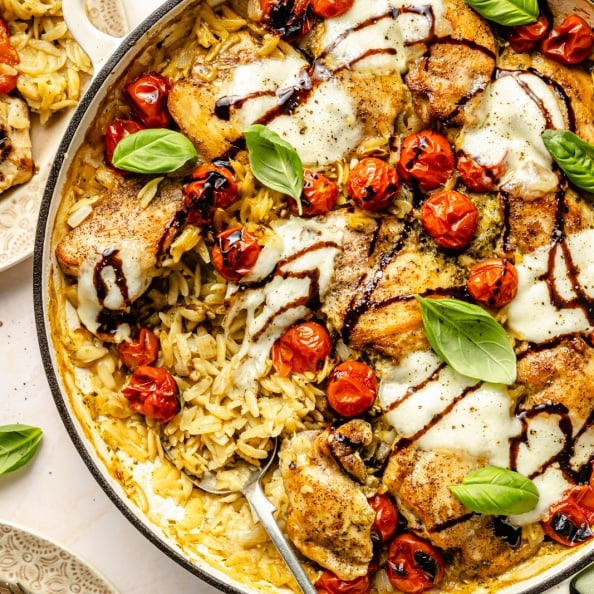 chicken caprese orzo bake in a pan