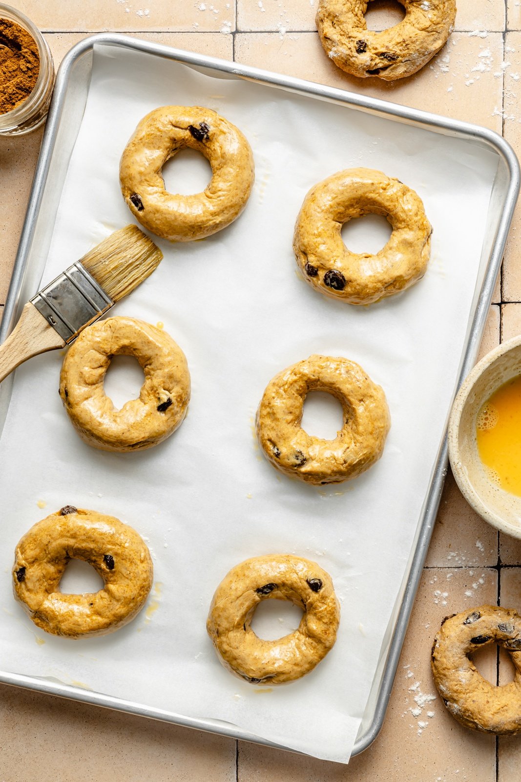 unbaked pumpkin protein bagels on a baking sheet