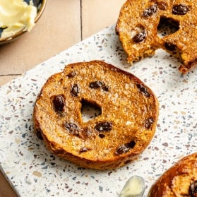 pumpkin protein bagel cut in half on a board