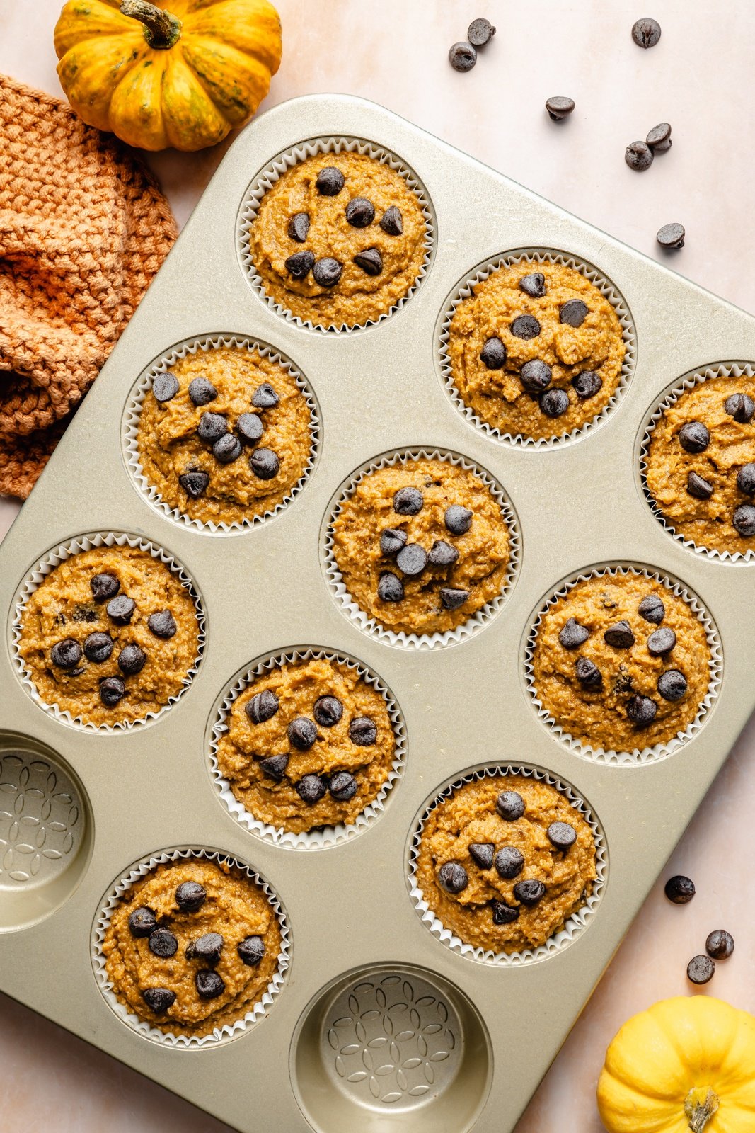 unbaked pumpkin protein muffins in a muffin tin