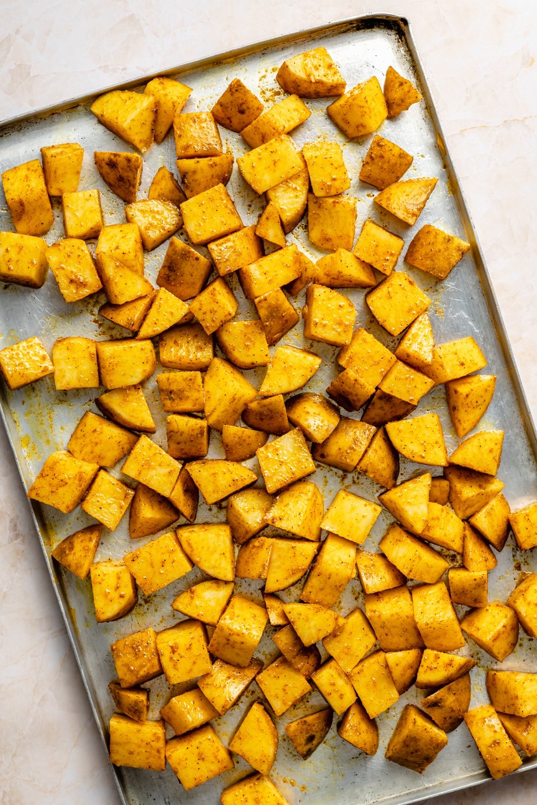 unbaked breakfast potatoes on a sheet pan