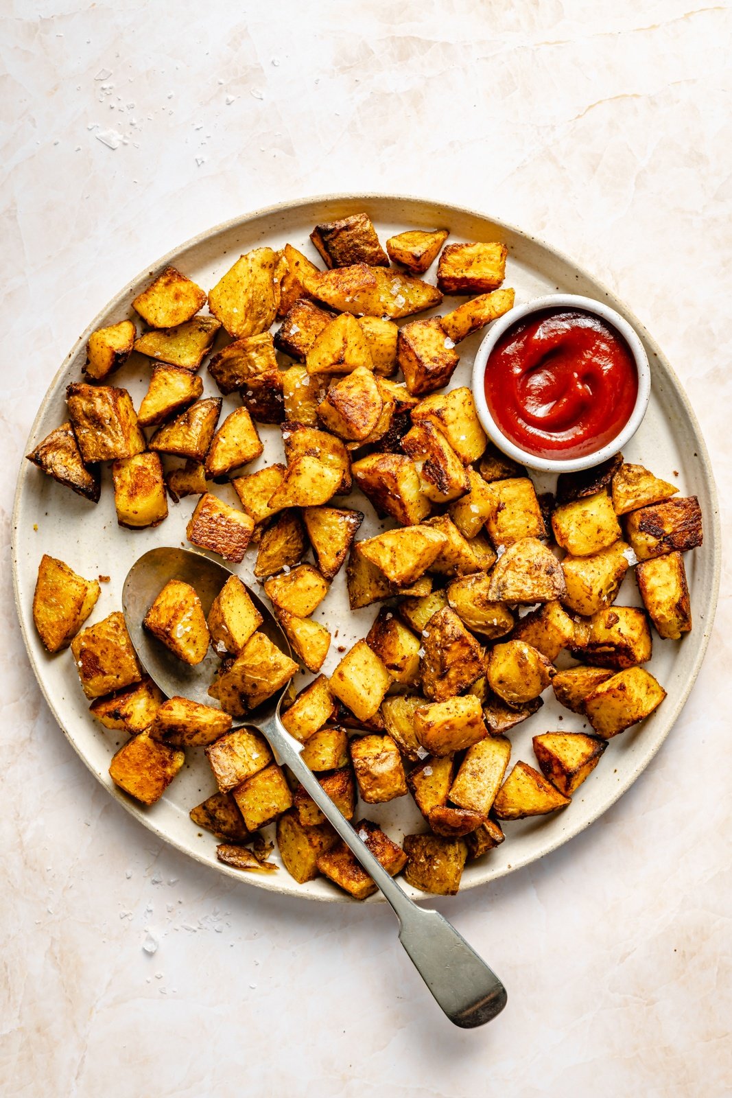 the best breakfast potatoes on a plate with ketchup