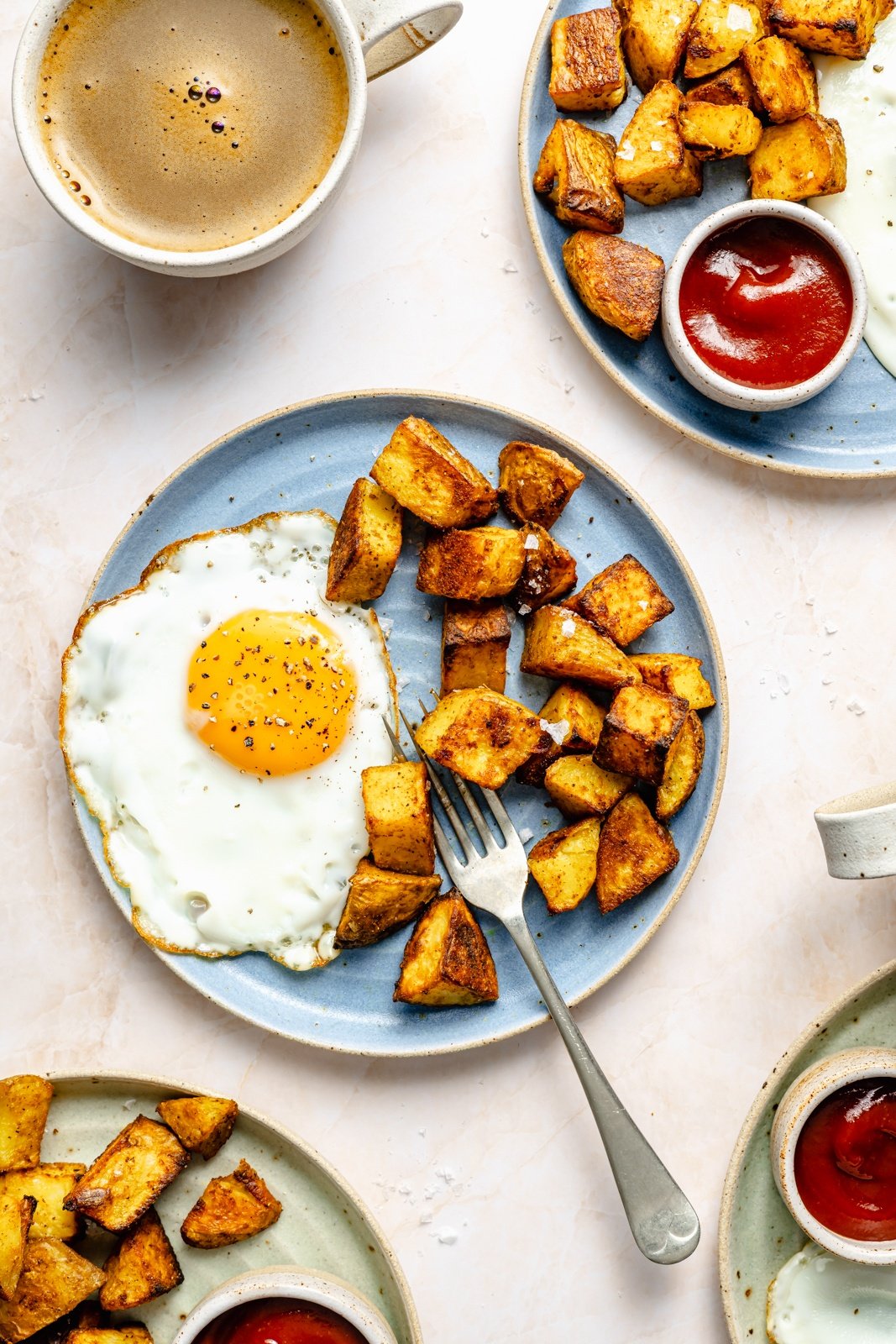 crispy breakfast potatoes on a plate with an egg
