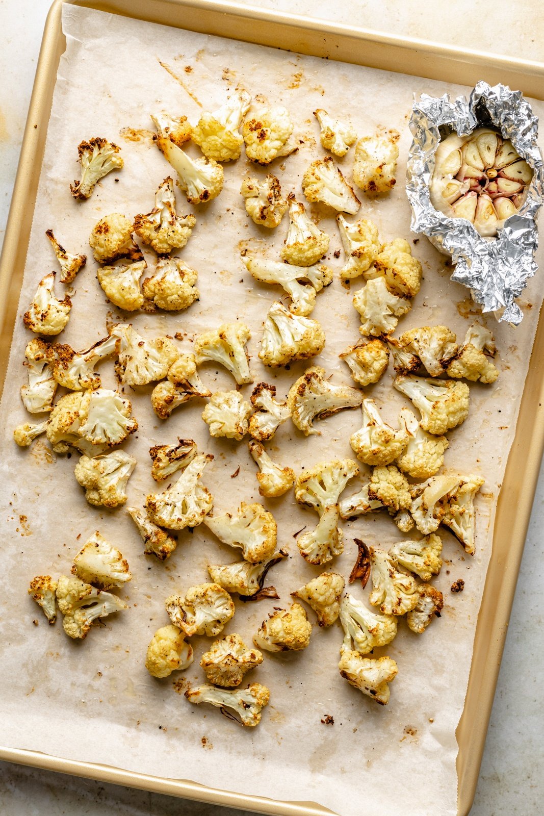 roasted cauliflower and garlic on a sheet pan