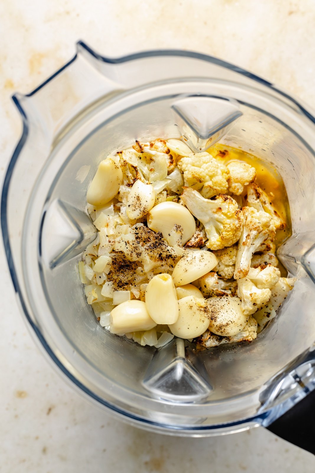 ingredients for buffalo roasted cauliflower soup in a blender
