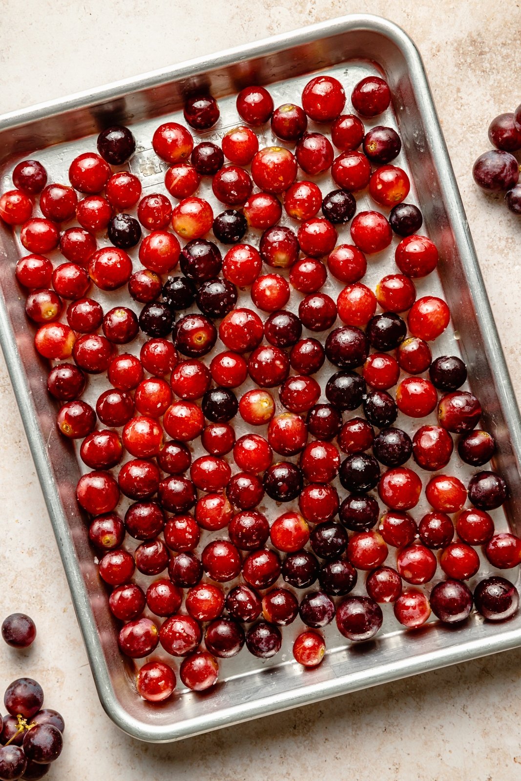 grapes on a baking sheet to make roasted grape and brie crostini