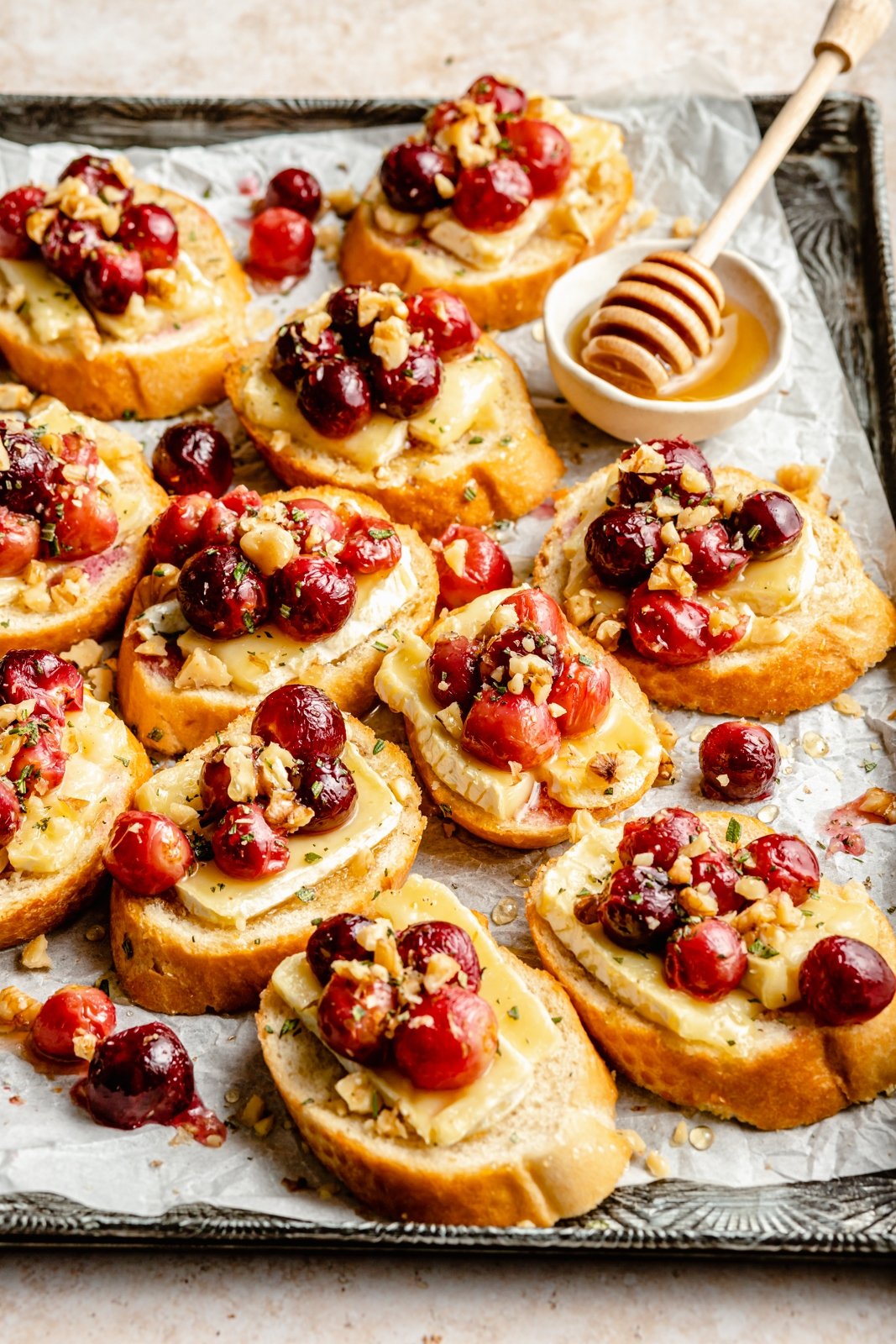 roasted grape and brie crostini on a baking sheet