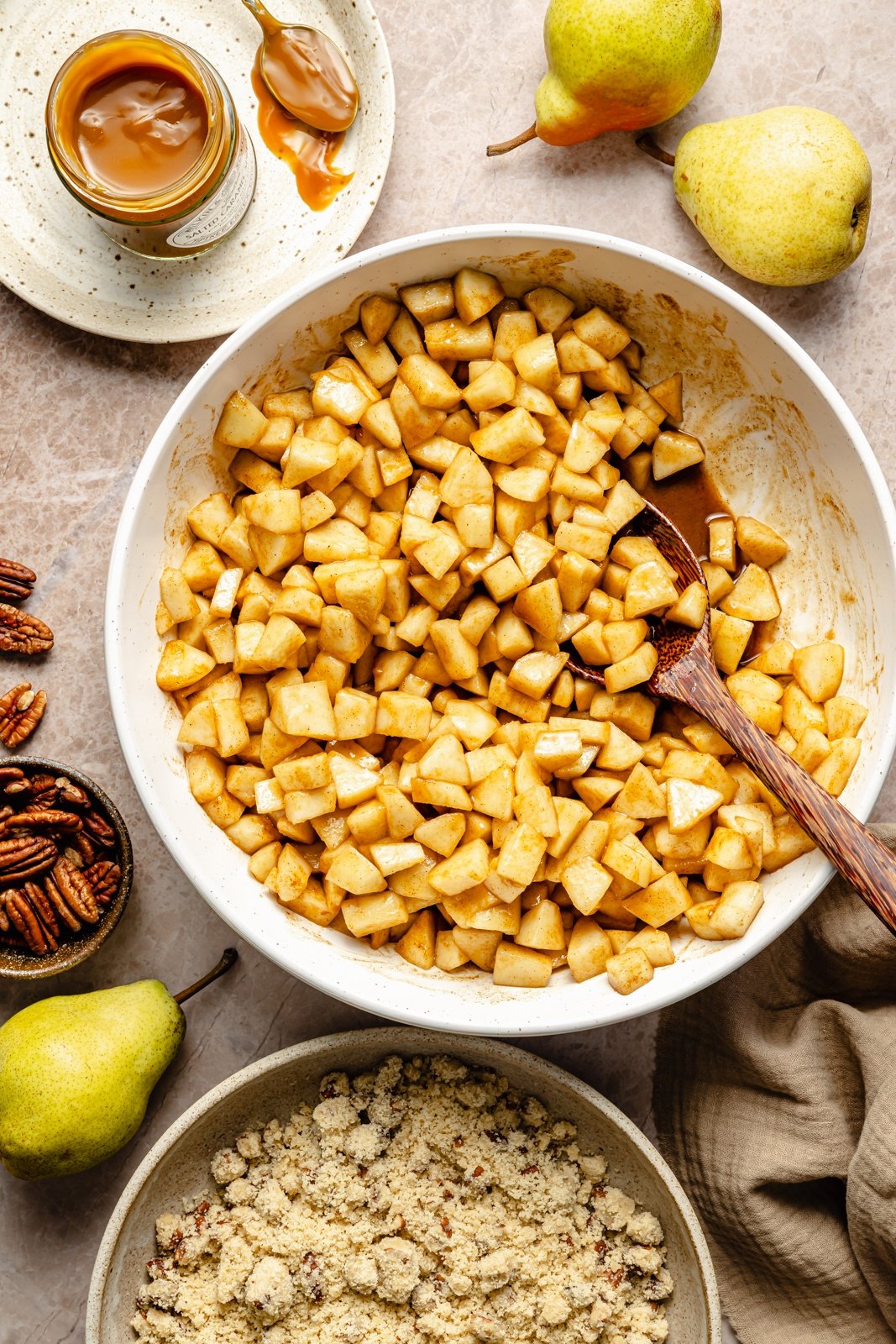 mixing pears in a bowl to make a pear pie