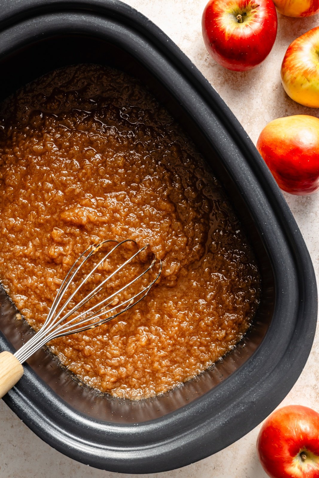 mixing easy homemade applesauce in a slow cooker