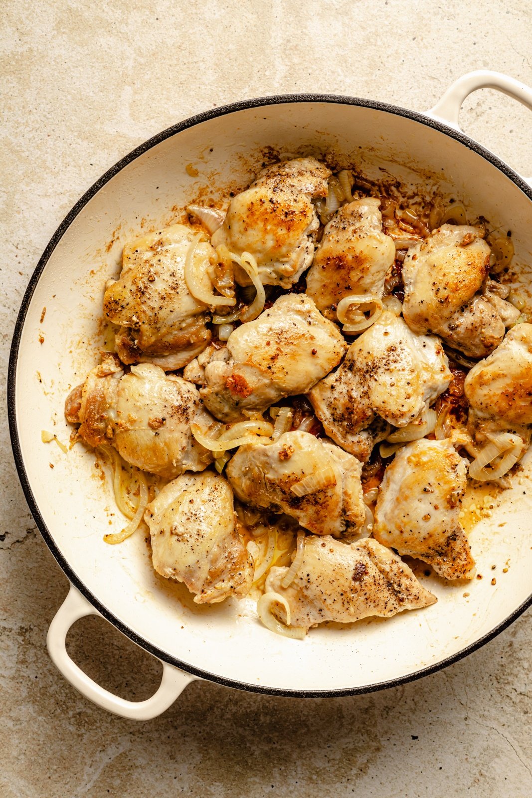 cooking chicken in a skillet to make Italian chicken sandwiches