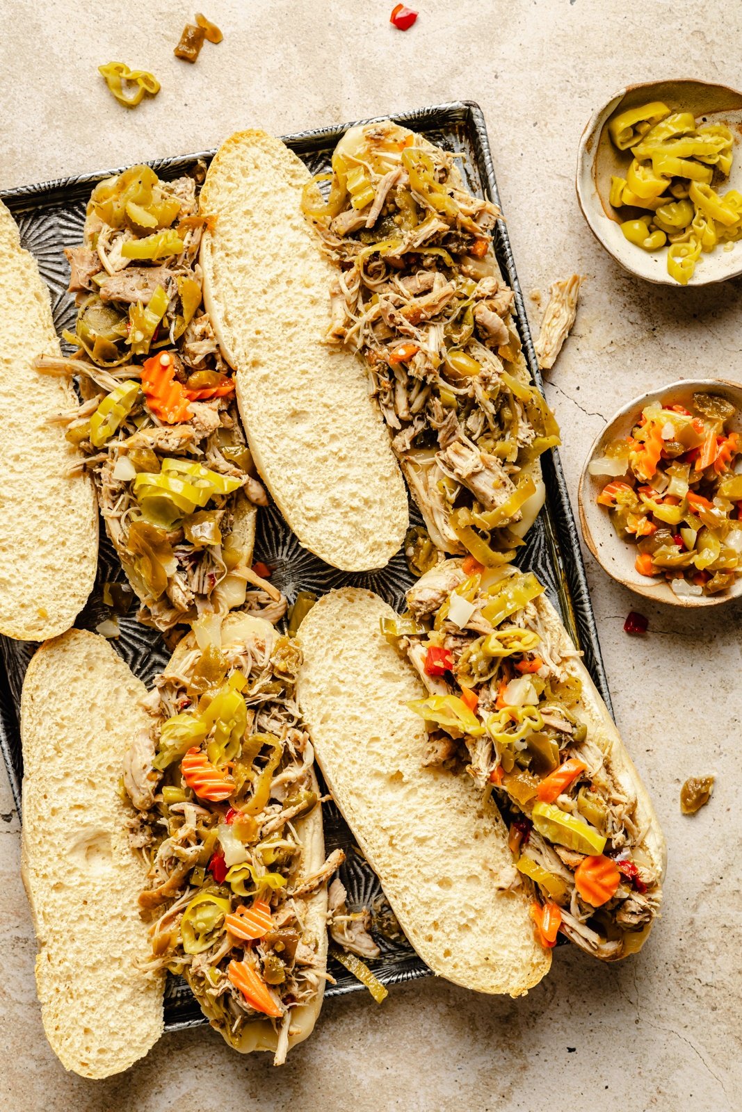 assembling Italian chicken sandwiches on a platter