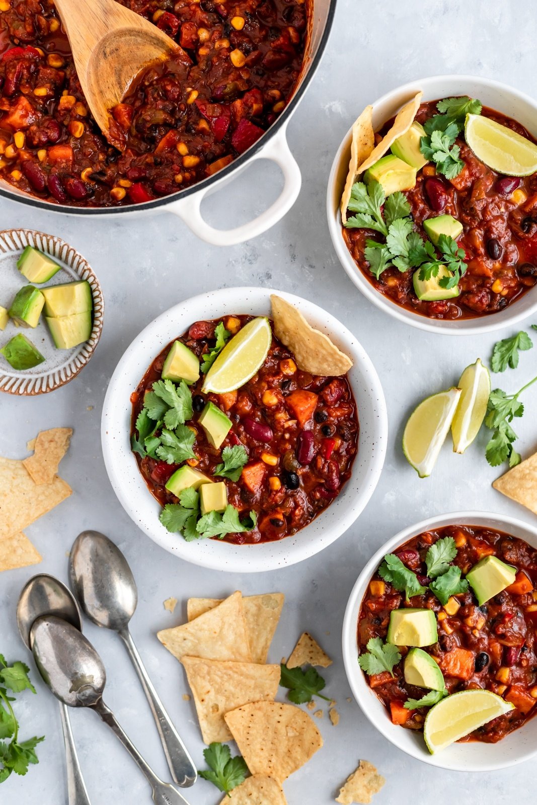 the best vegetarian chili in bowls with tortilla chips and toppings